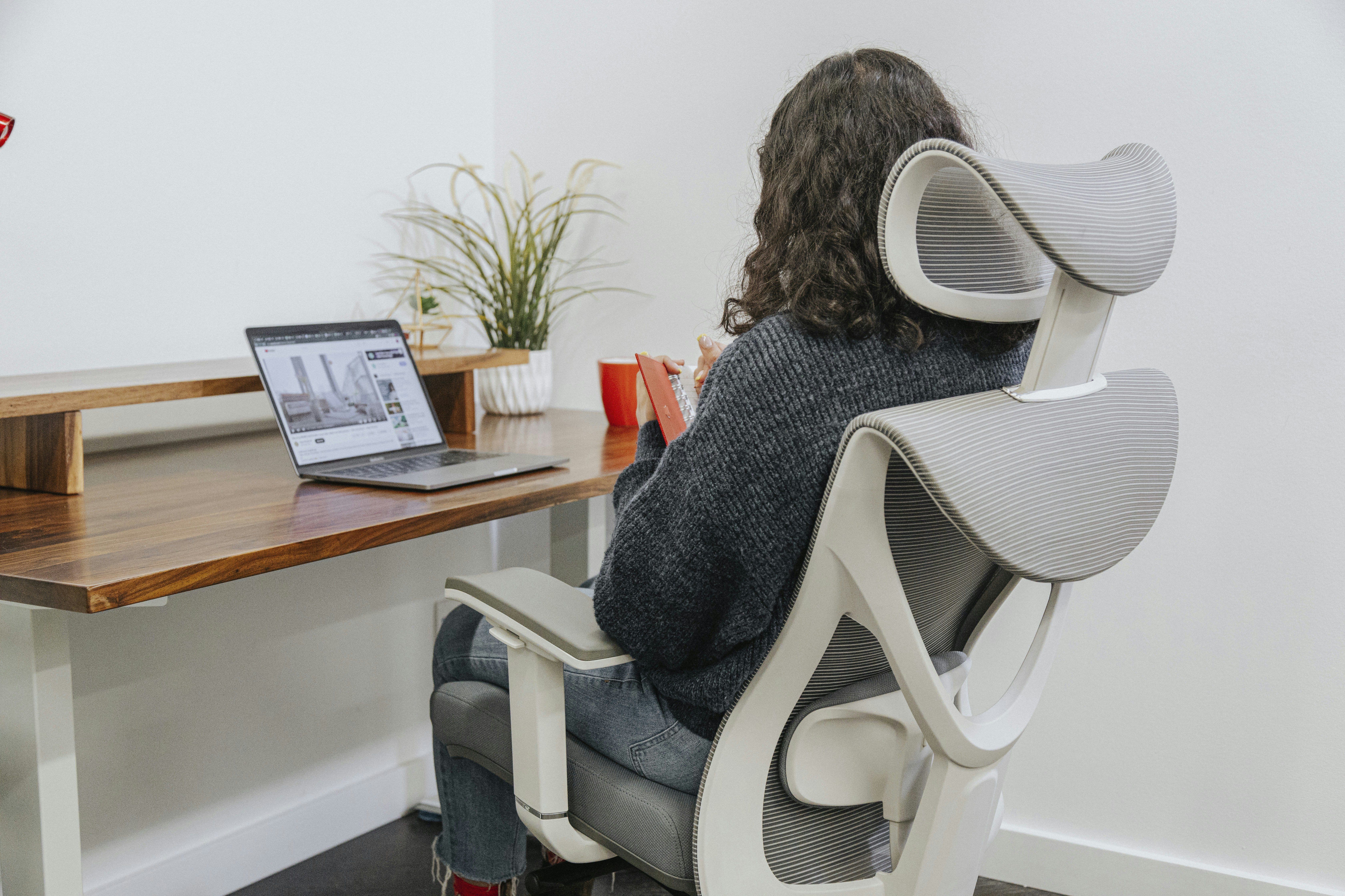 a woman sitting at a desk with a laptop